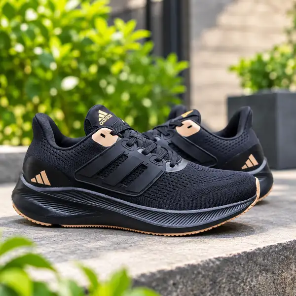 Adidas men's black running shoes with gold accents